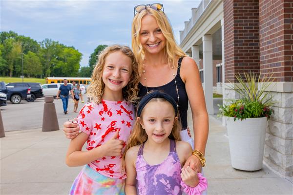 mom and two girl students in front of CSES